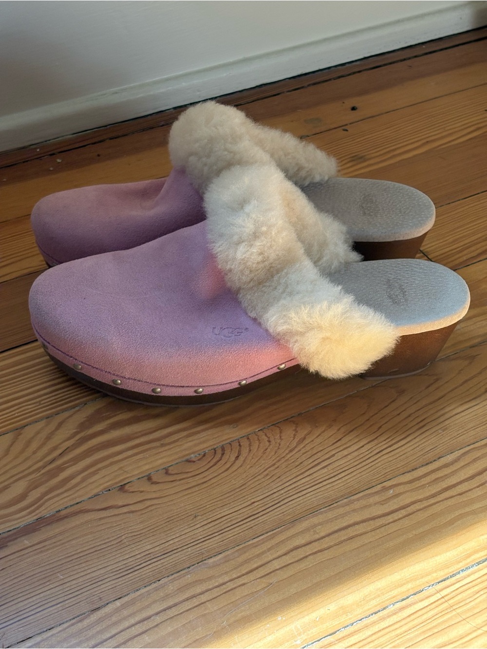 UGG clog winter sandals in a pink suede material with a shearling lining.